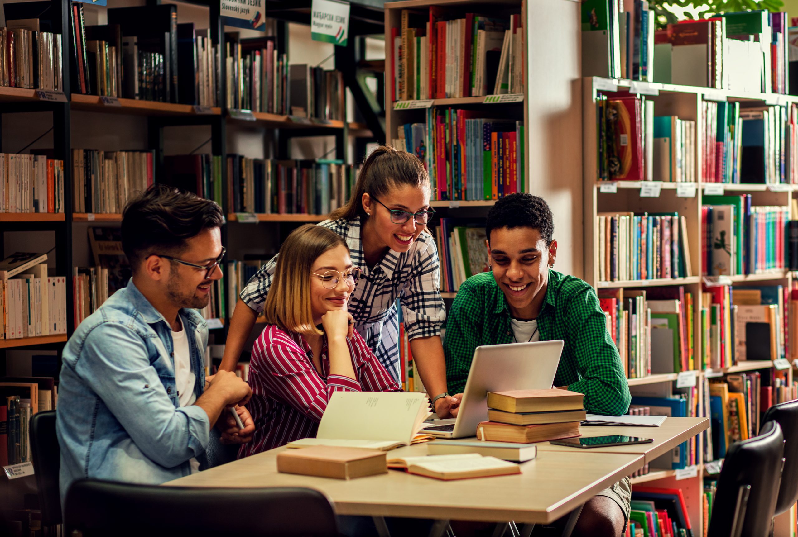 Adolescent kids sitting at a table in the library
